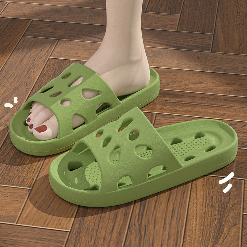 Green slippers on a wooden floor with cartoon feet illustration.